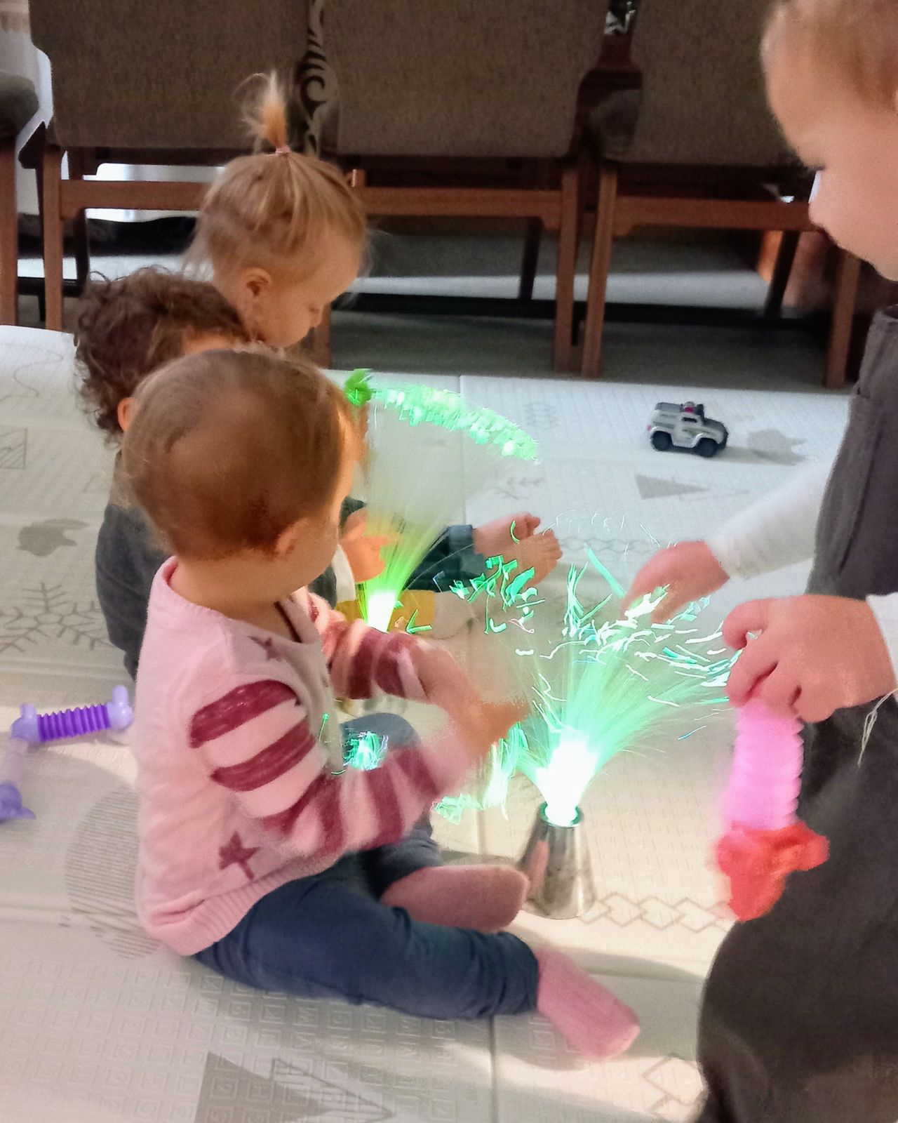 Toddlers exploring fibre-optic sensory lights at MiniMove Golders Green